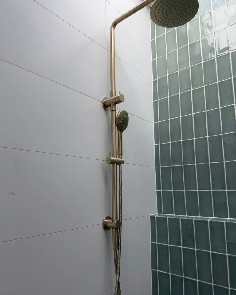 Brushed brass shower rail, set out to align with the grout lines