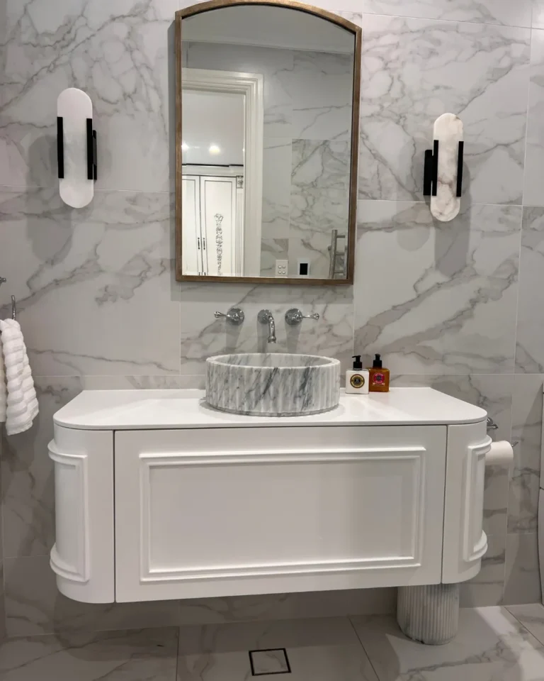 Curved vanity with fluted marble basin