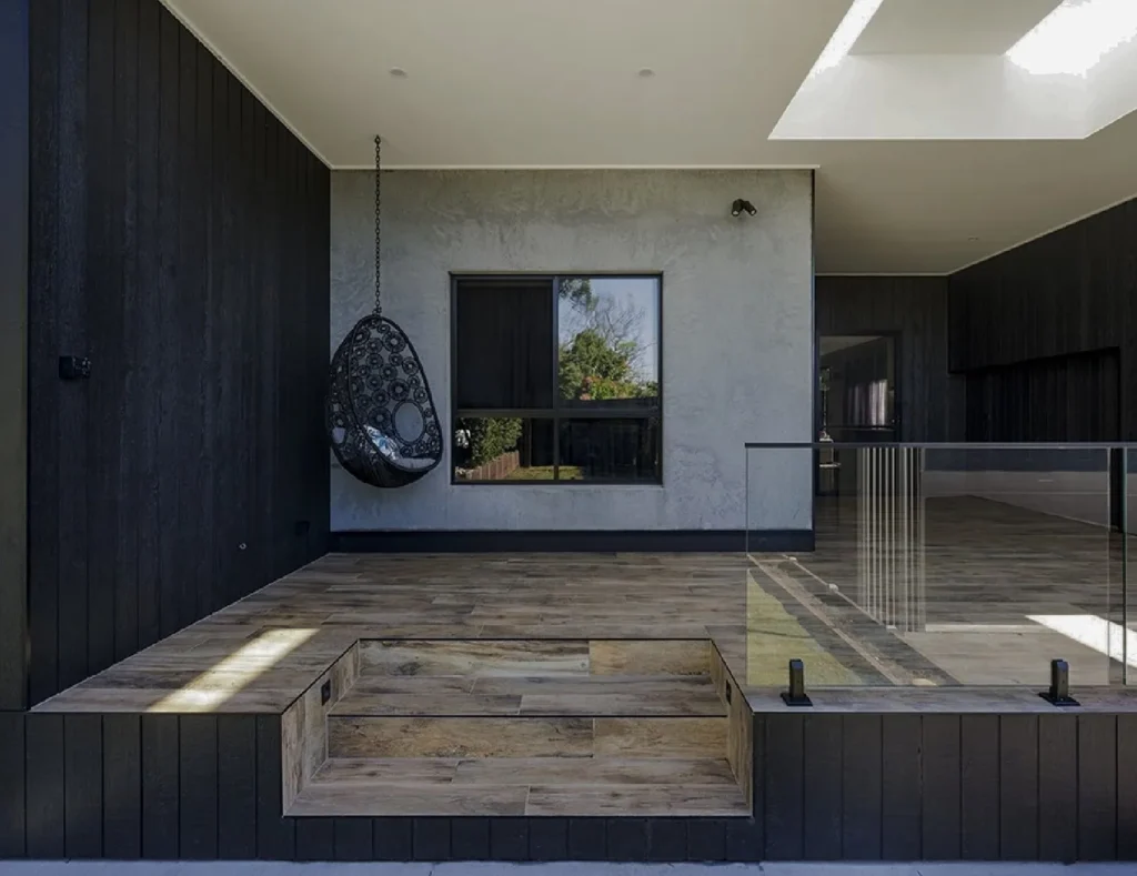 Alfresco addition with skylights and black-stained timber cladding