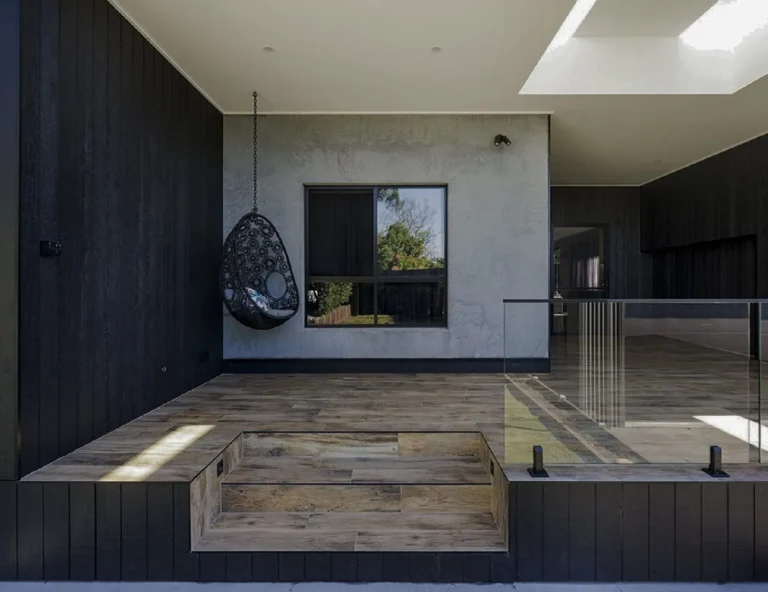 Alfresco addition with skylights and black-stained timber cladding