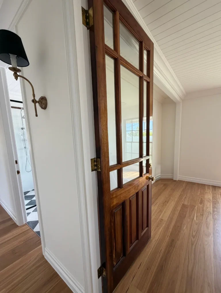 Restored glazed timber door and hallway