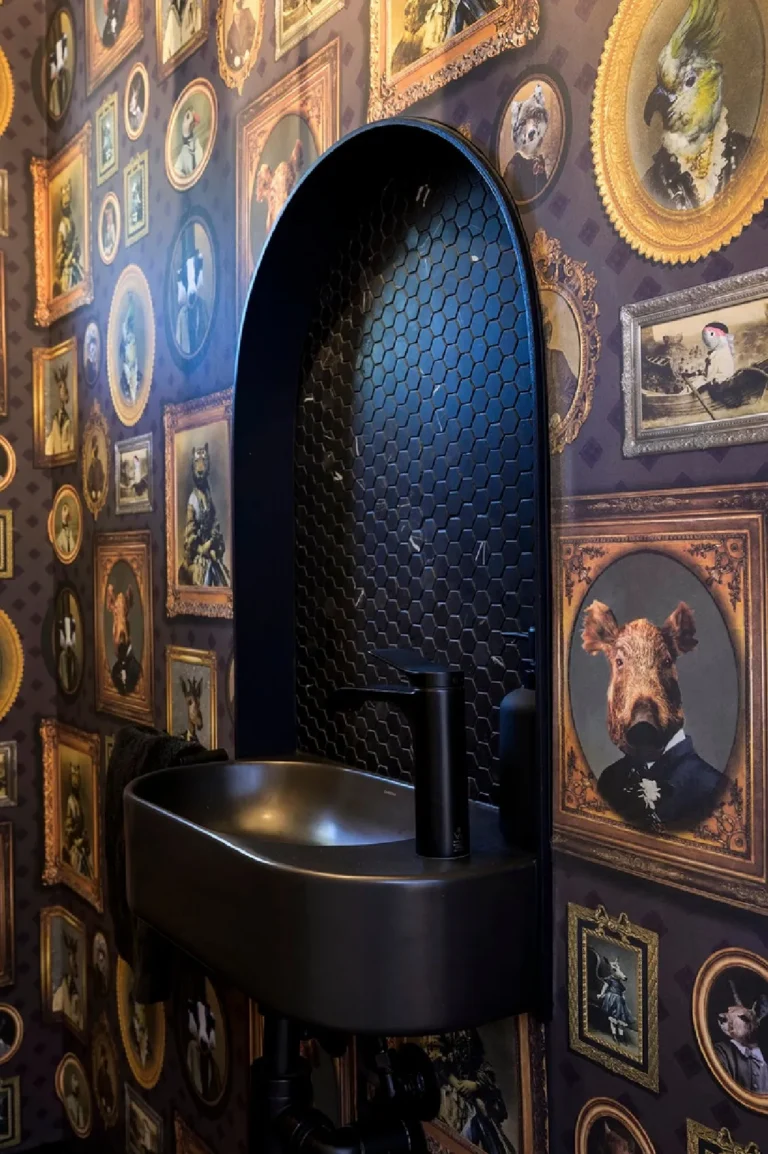Powder room with gallery wall and fluted arch