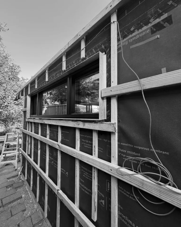 Weather-resistive barrier and cladding battens around new double-glazed windows